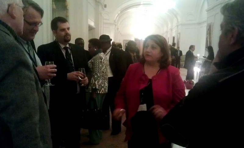 Honorable Ala Talabani, the newly elected President of the Parliamentary Forum\'s Board speaks with other attendees of the Forum